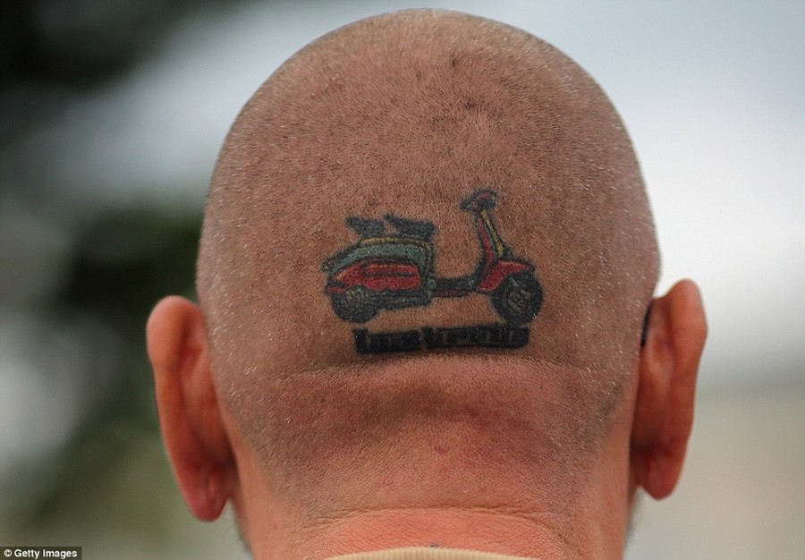 Die hard: A Lambretta enthusiasts shows off a tattoo making it clear which model he prefers 